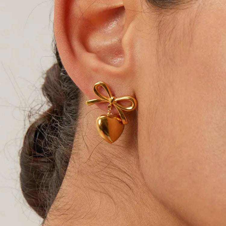 Bow earring with pendant heart